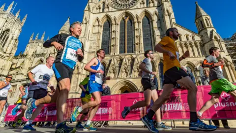 Yorkshire Marathon Runners pass York Minster