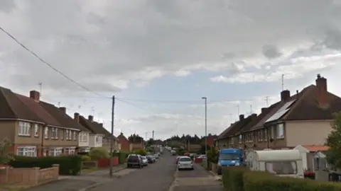 Google 1940s street with cars parked in the road