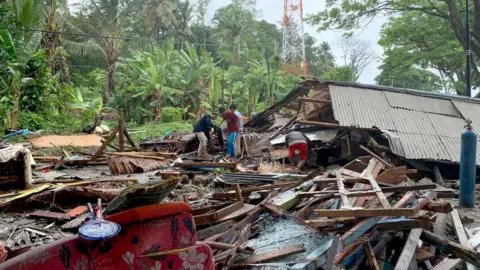 EPA Indonesian residents gathering their possessions near Anyer Beach