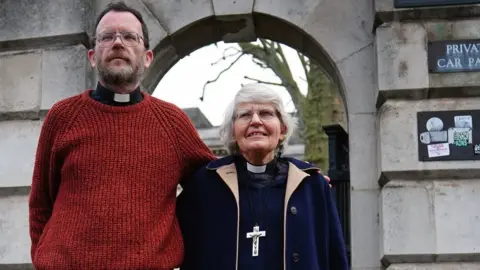 PA Media the Reverend Sue Parfitt, 79, Father Martin Newell,