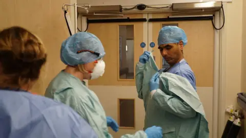 Dr Sanjiv Chohan (he’s the doc donning PPE)