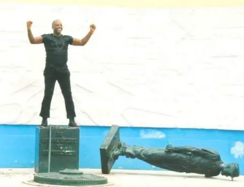 Andre Blaise Essama The first time Mr Essama toppled Gen Leclerc's statue in 2003