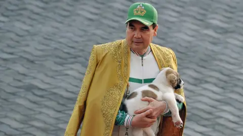 AFP Turkmenistan's President Gurbanguly Berdymukhamedov holds a Turkmen shepherd dog