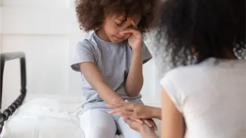 Getty Images sad child being comforted