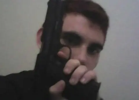 Instagram Nikolas Cruz, holding a gun in front of his face