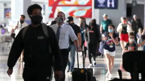 Getty Images Passengers walk through the United Airlines terminal at George Bush Intercontinental Airport on May 11, 2020 in Houston, Texas