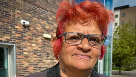 Sarah-Lee Evans standing in front of the court