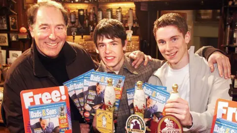 PA Media Fletcher (centre) with Emmerdale co-stars Clive Hornby (left) and Karl Davies in 2002