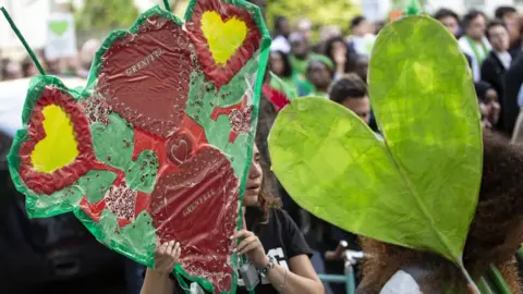 EPA People attend a silent walk by Grenfell Tower on one-year anniversary