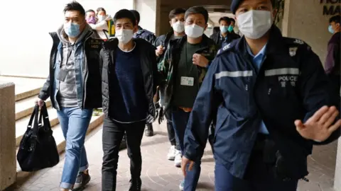 Reuters Lester Shum escorted by police officers