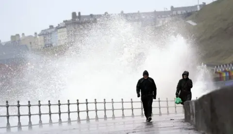 PA/Danny Lawson Big waves hit the sea wall at Whitby North Yorkshire