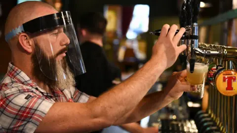 Reuters A bartender pours beer at a bar in Belfast