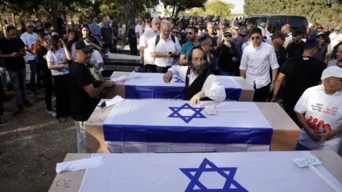 Getty Images Israelis hold funerals for those killed by Hamas in October 2023