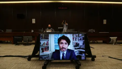 AFP via Getty Images Canada's Prime Minister Justin Trudeau testifies via video conference during a House of Commons Standing Committee on Finance