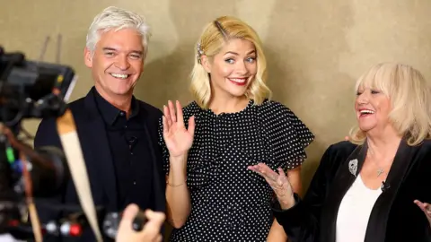 Getty Images Phillip Schofield, Holly Willoughby and Judy Finnigan