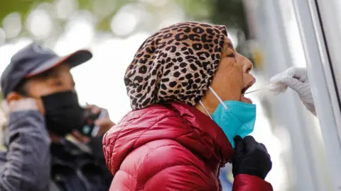 EPA A woman undergoes a PCR test as per routine testing in Beijing