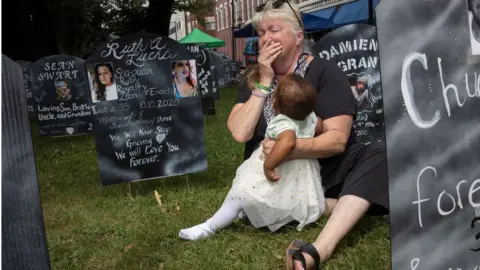 A woman at an event calling for the Sacklers to be prosecuted in 2021.