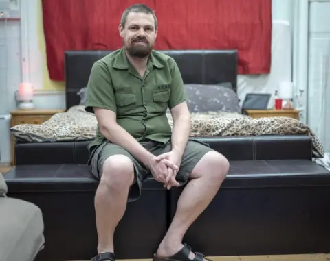 Phil Coomes Rex in his bedroom in the school he lives in