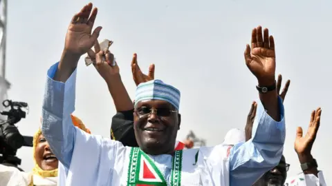 Getty Images Peoples Democratic Party (PDP) Atiku Abubakar with his hands raised during a campaign rally in Kano, northwest Nigeria