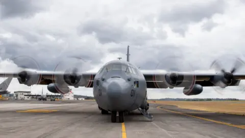 NZ DEFENCE FORCE A New Zealand Hercules aircraft carrying emergency supplies on the tarmac at Auckland Airport