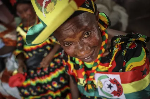 Andre Kosters/EPA A woman wears a dress, hat and necklace in colours of the Inclusive Alliance Platform party in Bissau, Guinea-Bissau - Monday 29 May 2023