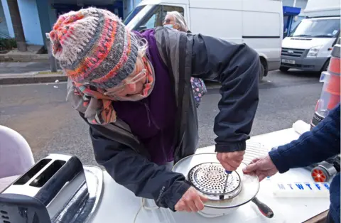 BBC Volunteers repair electrical items at the Fixing Factory in Camden, London