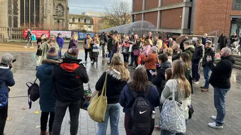 Tim Sparrow/BBC Sam Ryder busking in the centre of Norwich