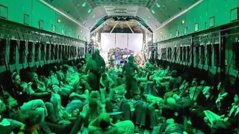 Spanish diplomatic personnel and citizen onboard a military plane after evacuation from Sudan