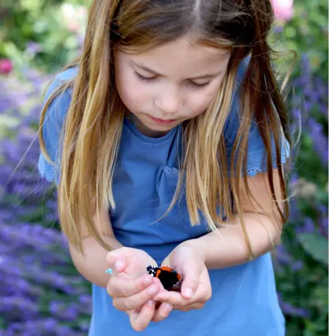 Duchess of Cambridge Princess Charlotte holding a butterfly