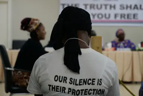 AFP A #IamToufah campaign supporter, listening to former Gambian beauty queen, Fatou Jallow, testifying before the country's Truth and Reconciliation Commission in Banjul on October 31, 2019