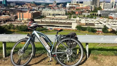 BBC A push bicycle stood up overlooking Sheffield