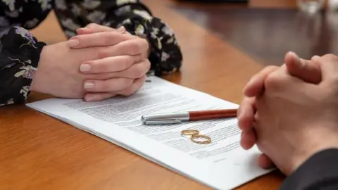 Getty Images Couple with divorce papers