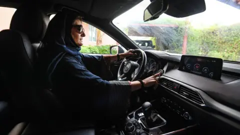 Getty Images Woman driving car