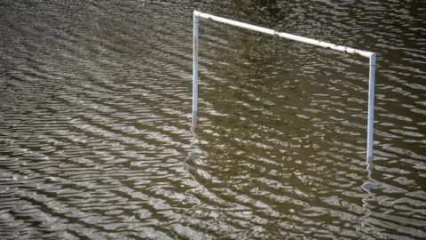 Getty Images Goalposts underwater on a flooded football pitch on January 12, 2022, in Taff’s Well, Wales