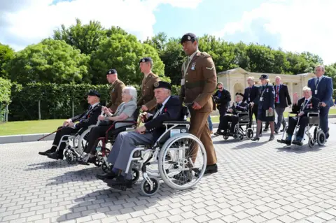 Getty Images Commemorations service at the war cemetery in Bayeux