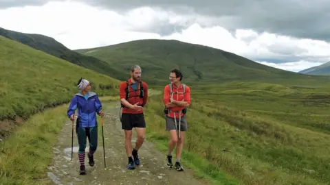 Berghaus Sabrina Verjee walks alongside Paul Tierney (centre) and Steve Birkinshaw