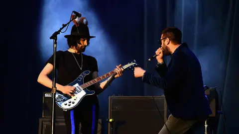 Getty Images Kasabian performing on stage