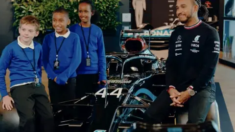 UBS Lewis Hamilton with the school pupils