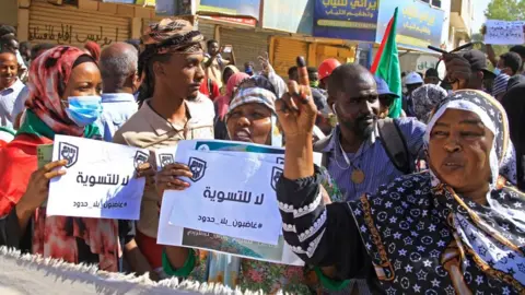 Getty Images Demonstrators march in a mass demonstration in rejection of a deal aimed at ending the crisis caused by the 2021 military coup