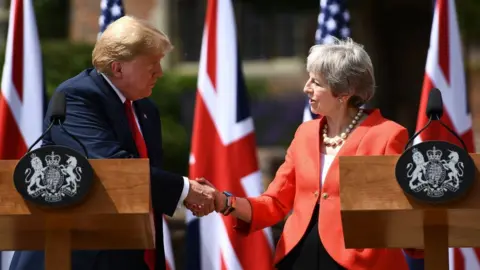 AFP Donald Trump and Theresa May shake hands at a joint press conference during the president's visit to the UK in July last year
