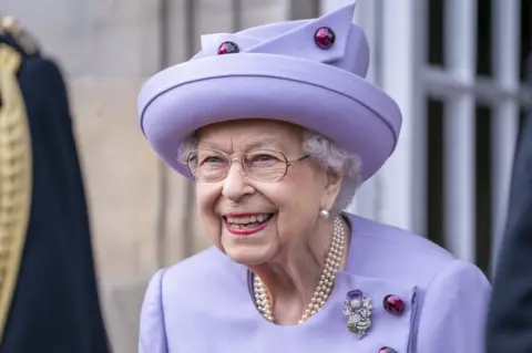 PA Media Queen Elizabeth II attends an armed forces act of loyalty parade in the gardens of the Palace of Holyroodhouse, Edinburgh, as they mark her platinum jubilee in Scotland. The ceremony was part of the Queen's traditional trip to Scotland for Holyrood Week. Picture taken on 28 June 2022