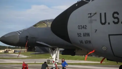 Getty Images A US Air Force Rockwell B-1B Lancer (left) and a Boeing KC-135 Stratotanker (right) sit on the tarmac at Andersen Air Force base in Yigo, Guam (17 August 2017)