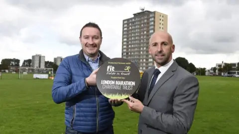 PA Belfast City councillor Adam Newton on Cregagh Green with Terry Housden of Fields in Trust