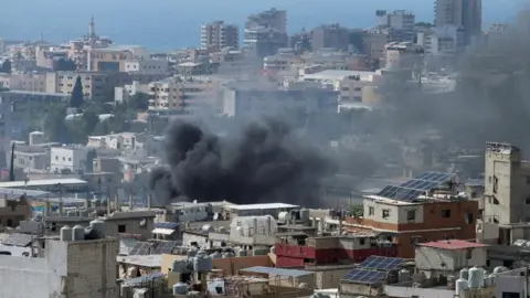 Smoke rises from Ain el-Hilweh Palestinian refugee camp during Palestinian faction clashes, in Lebanon