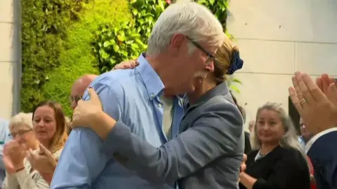 Danish PM's office Mette Frederiksen hugs Poul-Erik Rasmussen, who campaigned for years for an apology
