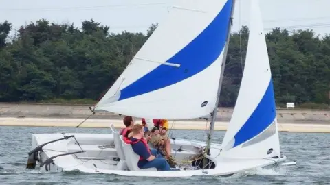 Hanningfield Sailability Club A sailability boat on the water at Hanningfield Reservoir