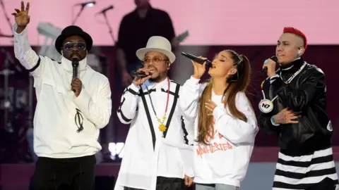 Getty Images Ariana Grande with the Black Eyed Peas