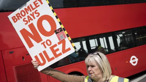 Getty Images Women protesting against the ULEZ expansion