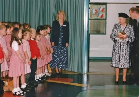 Prudhoe Local History Society Prudhoe West School Years 3 and 4 choir sang for the Queen, accompanied by teacher, Anne Walker