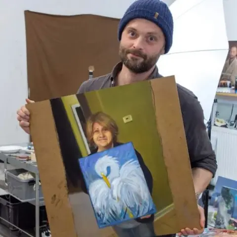 k_z Kristoffer Zetterstrand with his painting of Cindi Decker and her painting